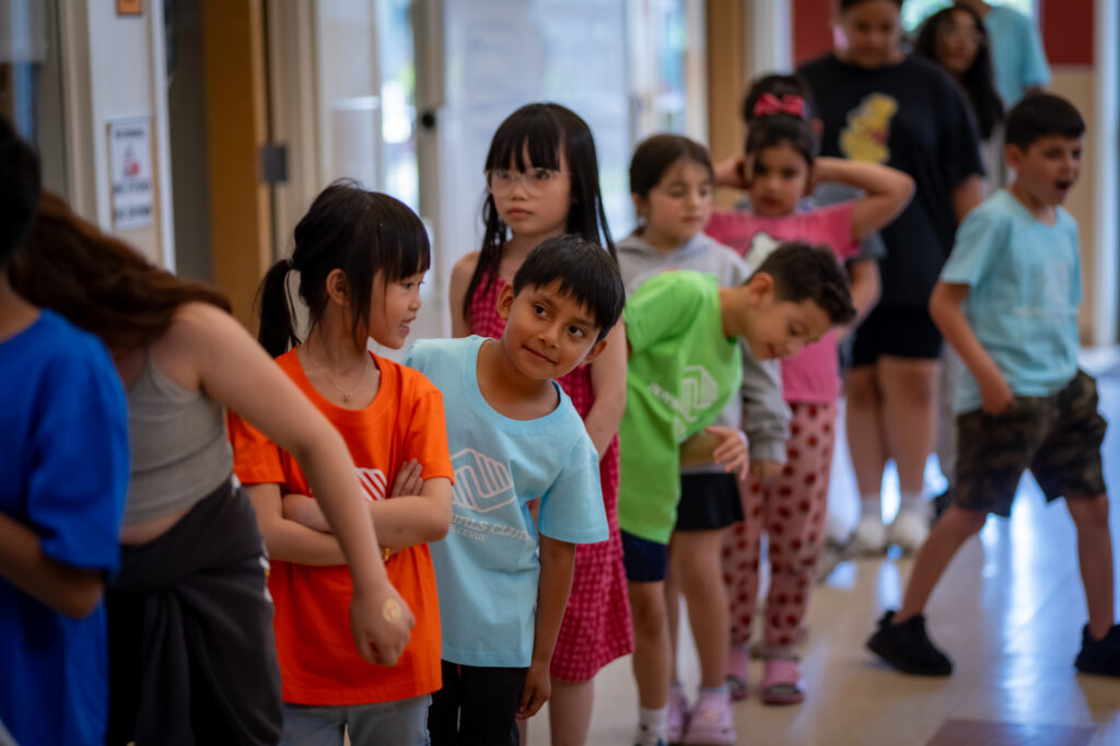 Kids lined up with colorful club shirts at BGCB Spiritwood Manor.