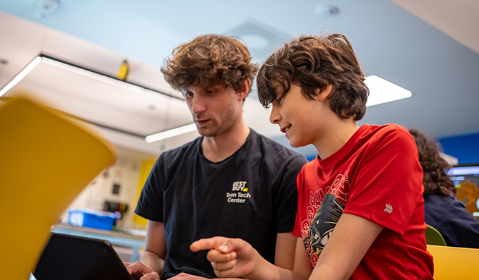 A Teen Center Staff mentoring a young teen.
