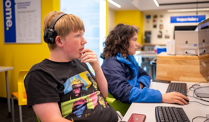 Teen sitting at computers in the Boys & Girls Clubs of Bellevue Tech Center